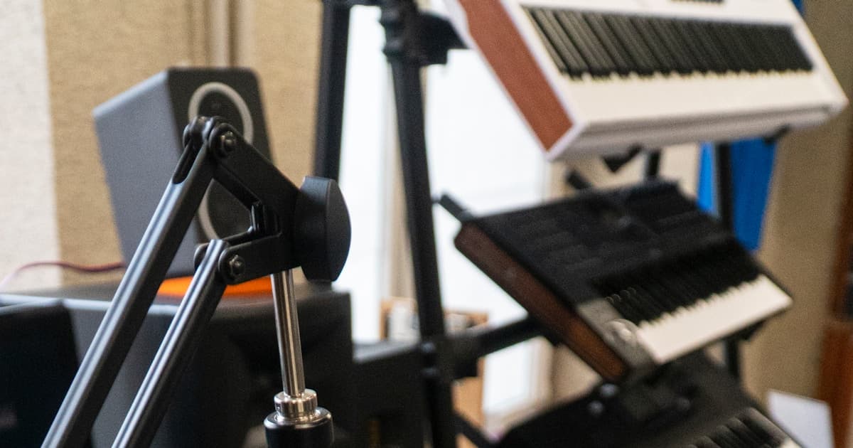 A recording studio microphone and keyboard representing AI voice cloning